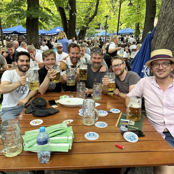 Guests sharing food and beer around a table